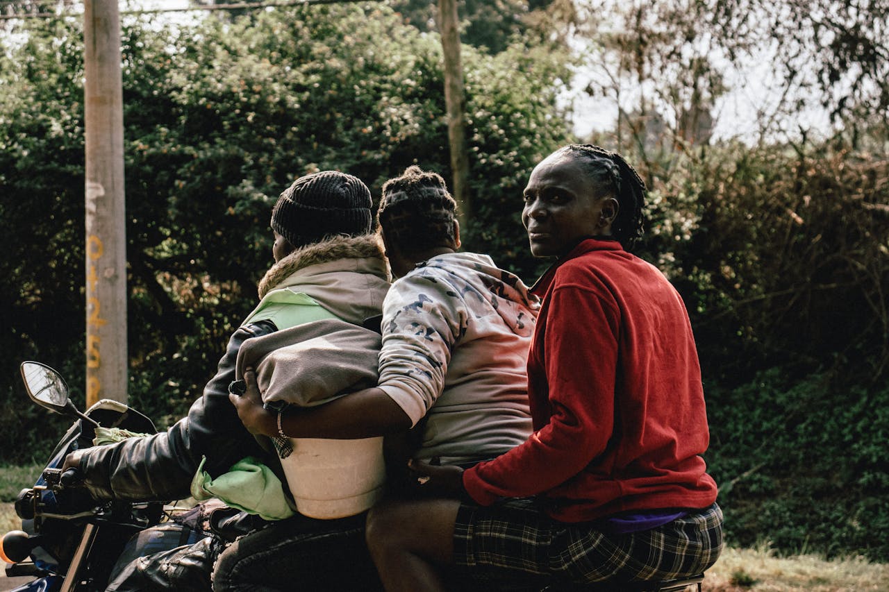 service-05 A family takes a motorcycle ride in Nairobi, showcasing daily life and transportation in Kenya.